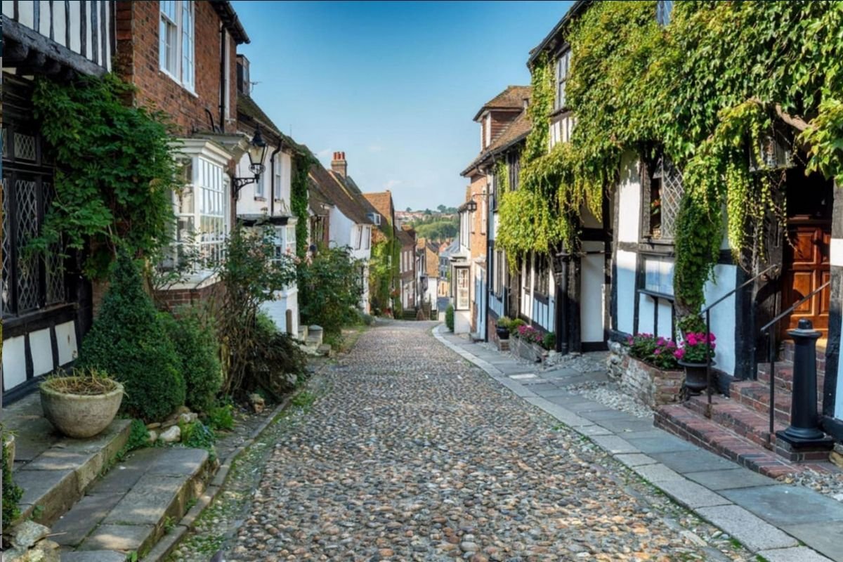 Cobbled Mermaid Street in Rye with timber-framed houses and climbing plants